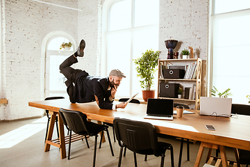 Image showing Businessman having fun dancing break dance in the office at work