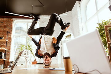 Image showing Businessman having fun dancing break dance in the office at work