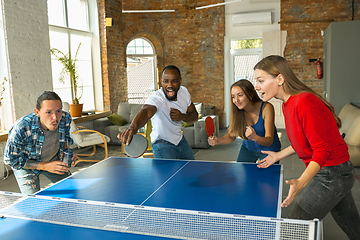 Image showing Young people playing table tennis in workplace, having fun