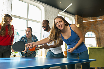 Image showing Young people playing table tennis in workplace, having fun