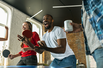 Image showing Young people playing table tennis in workplace, having fun