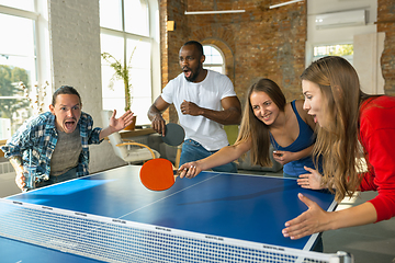 Image showing Young people playing table tennis in workplace, having fun