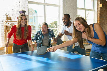 Image showing Young people playing table tennis in workplace, having fun