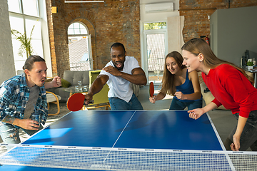 Image showing Young people playing table tennis in workplace, having fun