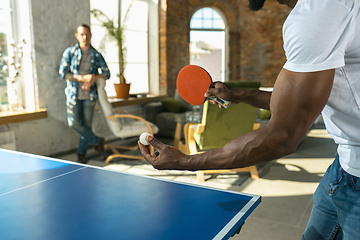 Image showing Young men playing table tennis in workplace, having fun