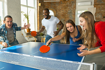 Image showing Young people playing table tennis in workplace, having fun