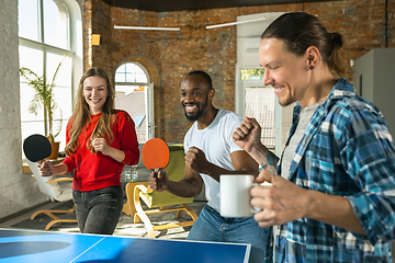 Image showing Young people playing table tennis in workplace, having fun