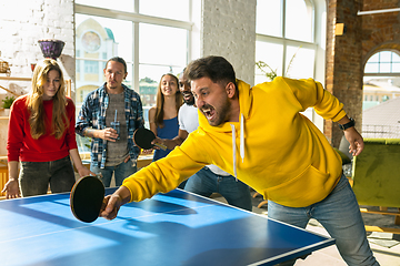 Image showing Young people playing table tennis in workplace, having fun