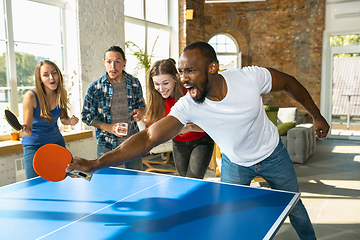 Image showing Young people playing table tennis in workplace, having fun