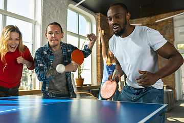 Image showing Young people playing table tennis in workplace, having fun