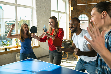 Image showing Young people playing table tennis in workplace, having fun