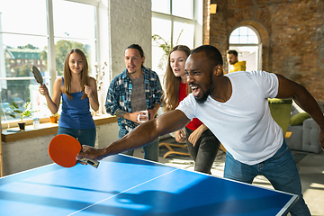 Image showing Young people playing table tennis in workplace, having fun