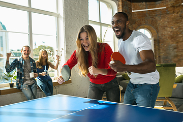 Image showing Young people playing table tennis in workplace, having fun