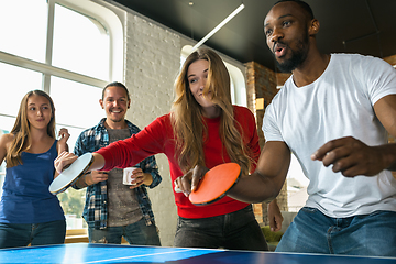 Image showing Young people playing table tennis in workplace, having fun