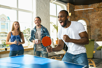 Image showing Young people playing table tennis in workplace, having fun