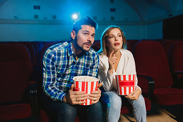 Image showing Attractive young caucasian couple watching a film at a movie theater