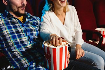 Image showing Attractive young caucasian couple watching a film at a movie theater