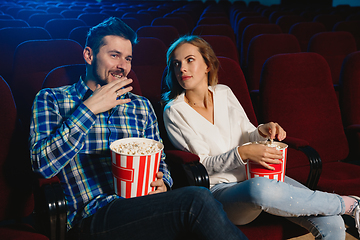 Image showing Attractive young caucasian couple watching a film at a movie theater