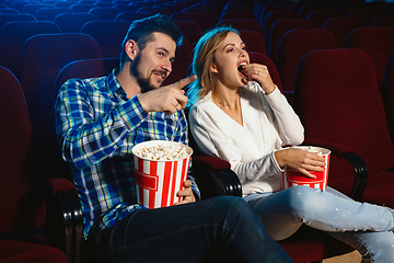 Image showing Attractive young caucasian couple watching a film at a movie theater