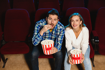 Image showing Attractive young caucasian couple watching a film at a movie theater