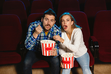 Image showing Attractive young caucasian couple watching a film at a movie theater