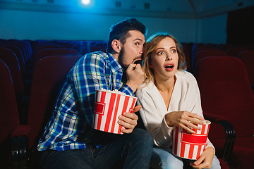 Image showing Attractive young caucasian couple watching a film at a movie theater