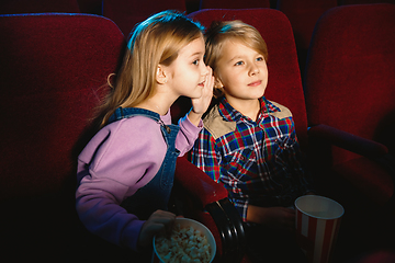 Image showing Little girl and boy watching a film at a movie theater