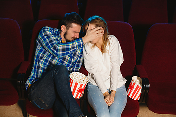 Image showing Attractive young caucasian couple watching a film at a movie theater