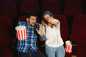 Image showing Attractive young caucasian couple watching a film at a movie theater