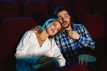 Image showing Attractive young caucasian couple watching a film at a movie theater