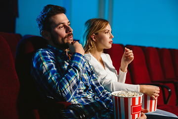 Image showing Attractive young caucasian couple watching a film at a movie theater