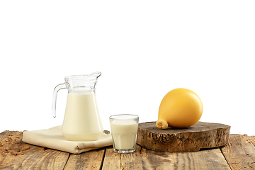 Image showing Different milk products, cheese, cream, milk on wooden table and white background.