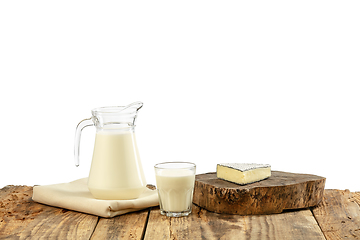 Image showing Different milk products, cheese, cream, milk on wooden table and white background.