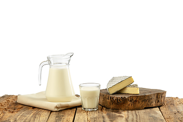 Image showing Different milk products, cheese, cream, milk on wooden table and white background.