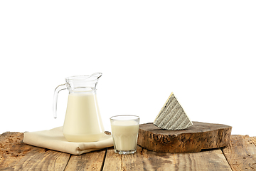 Image showing Different milk products, cheese, cream, milk on wooden table and white background.