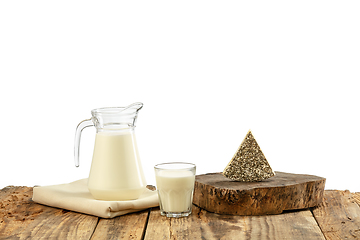 Image showing Different milk products, cheese, cream, milk on wooden table and white background.