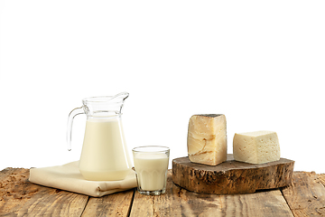 Image showing Different milk products, cheese, cream, milk on wooden table and white background.