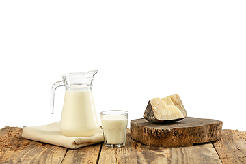 Image showing Different milk products, cheese, cream, milk on wooden table and white background.