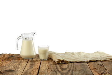 Image showing Different milk products, cheese, cream, milk on wooden table and white background.