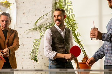 Image showing Young people playing table tennis in workplace, having fun