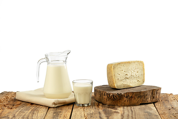 Image showing Different milk products, cheese, cream, milk on wooden table and white background.