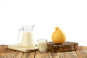 Image showing Different milk products, cheese, cream, milk on wooden table and white background.