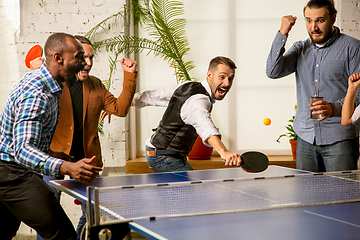 Image showing Young people playing table tennis in workplace, having fun