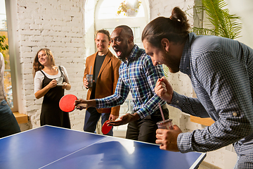 Image showing Young people playing table tennis in workplace, having fun