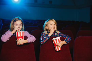 Image showing Little girl and boy watching a film at a movie theater