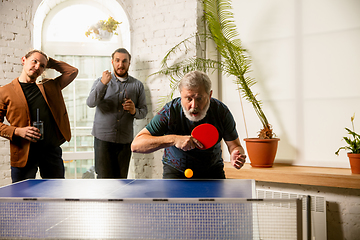 Image showing Young people playing table tennis in workplace, having fun