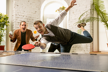 Image showing Young people playing table tennis in workplace, having fun