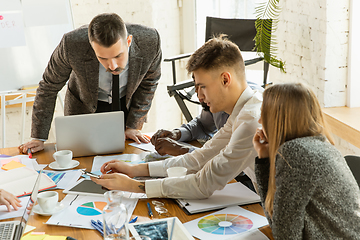 Image showing Group of young business professionals having a meeting, creative office