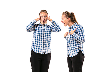 Image showing Young handsome woman arguing with herself on white studio background.