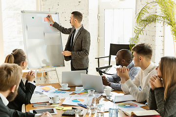 Image showing Group of young business professionals having a meeting, creative office